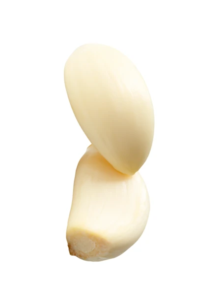 Two peeled garlic cloves isolated on white background