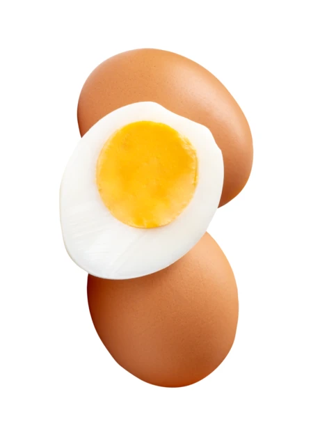 Boiled brown eggs and a sliced half egg on white